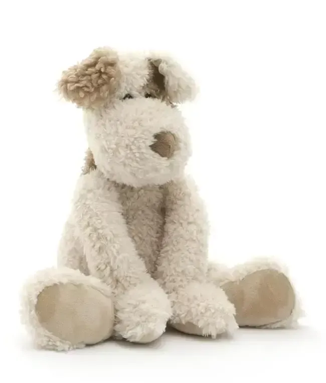 Stuffed dog with cream fur, tan ears and paws, sitting down.