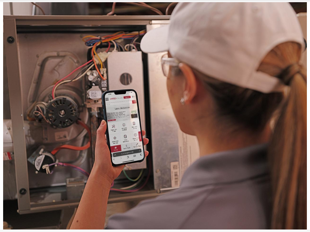 A residential water heater and boiler system, with connecting pipes, in a basement setting.