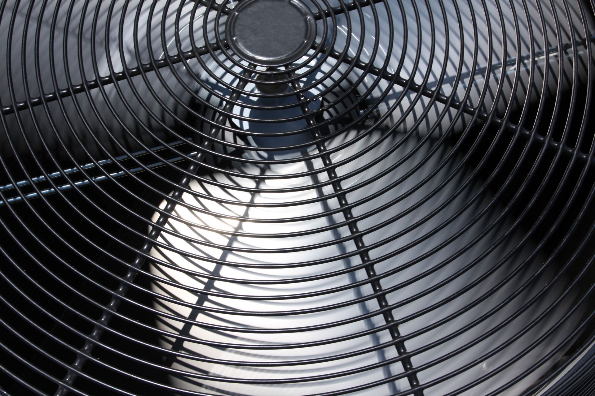 Close-up view of a black metal fan cage.