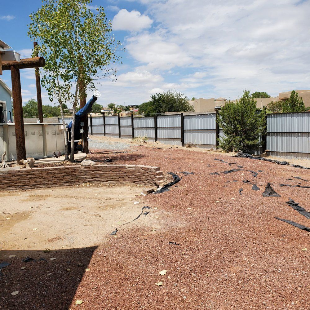 A fenced in yard with a cannon in the middle