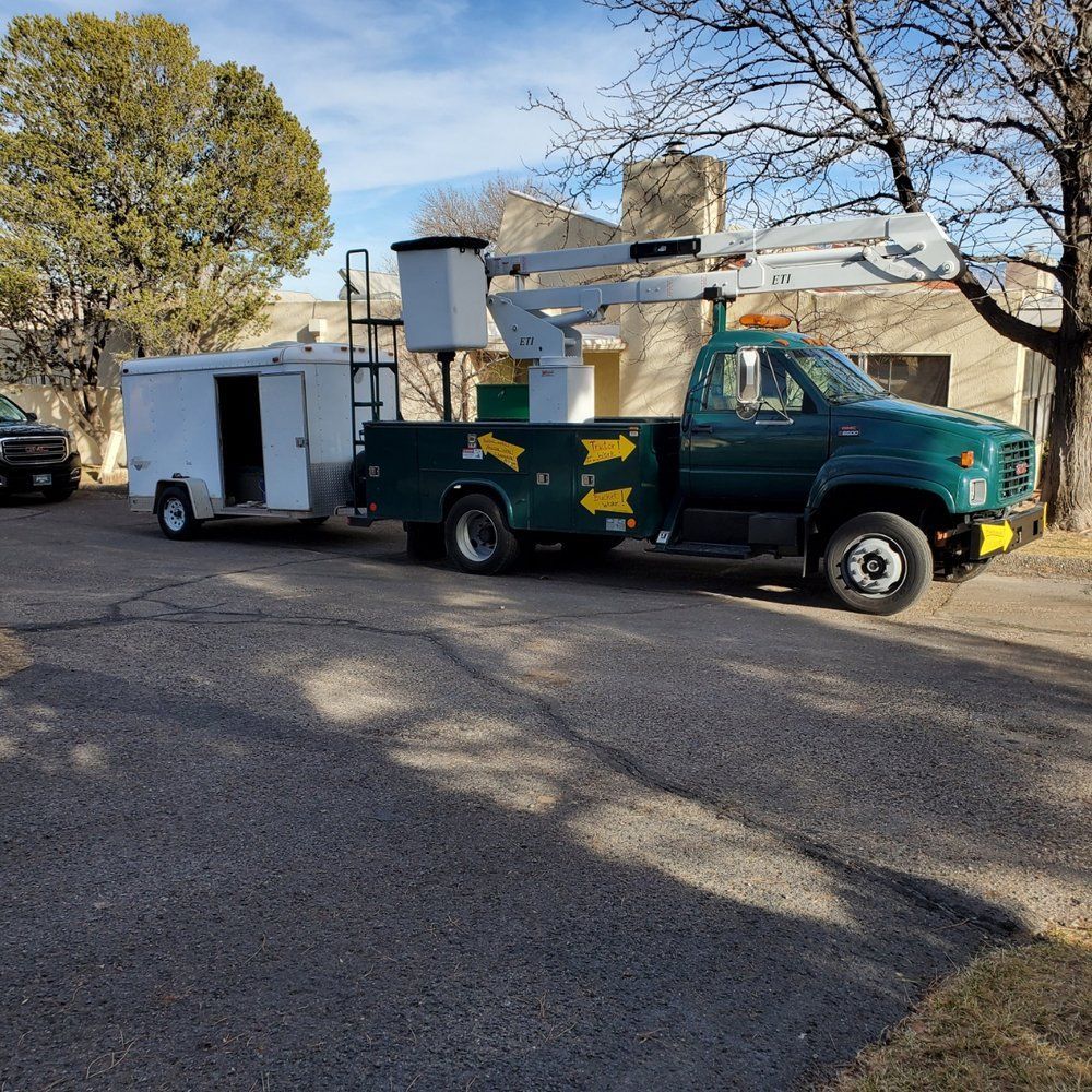 A green truck with a white trailer attached to it