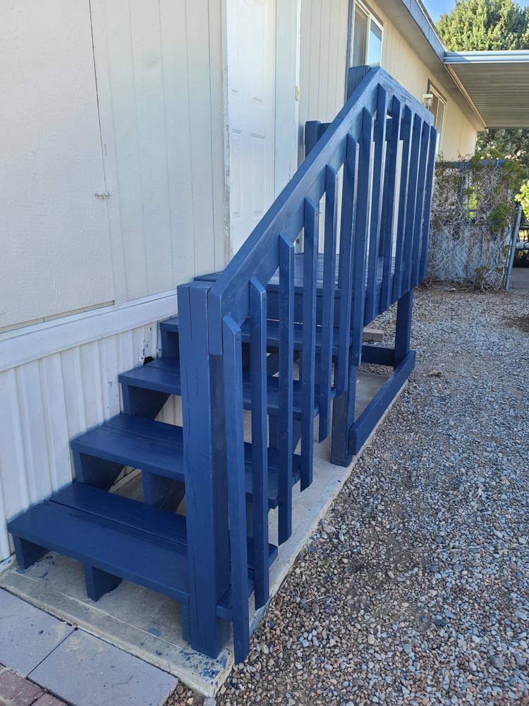 The stairs are painted blue and the railing is painted blue.