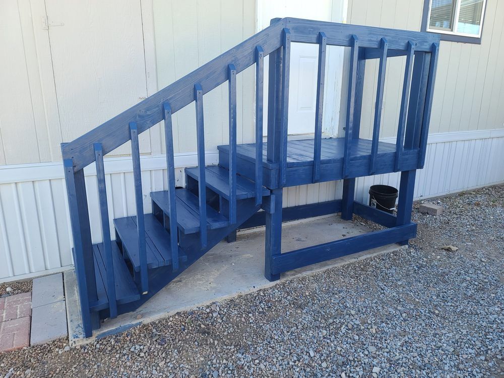The stairs are painted blue and the railing is painted white.