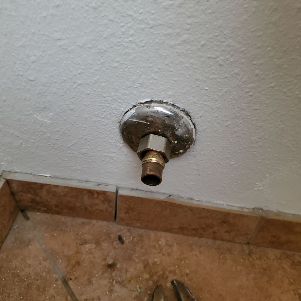 A close up of a faucet on a wall.