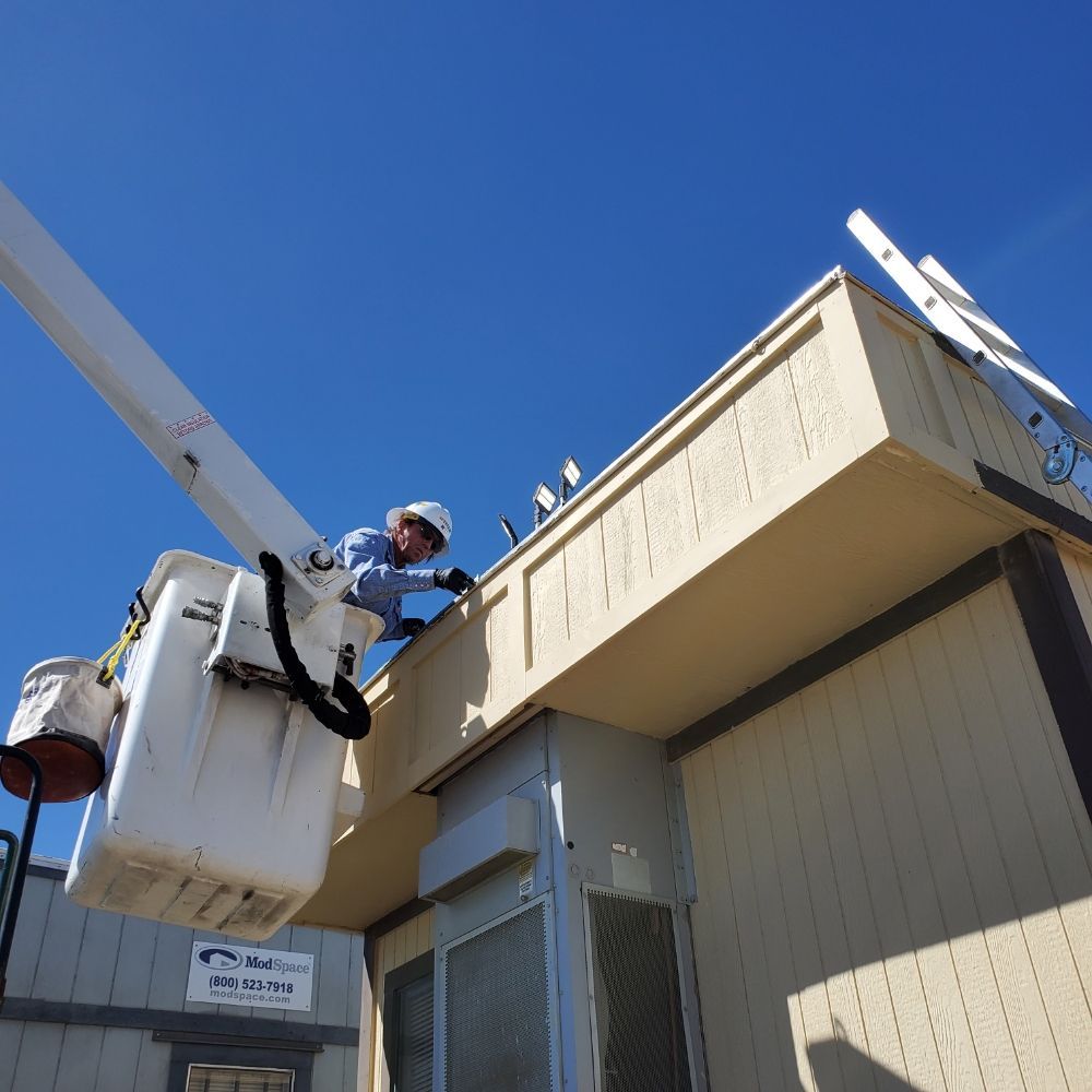 A man is working on the roof of a building