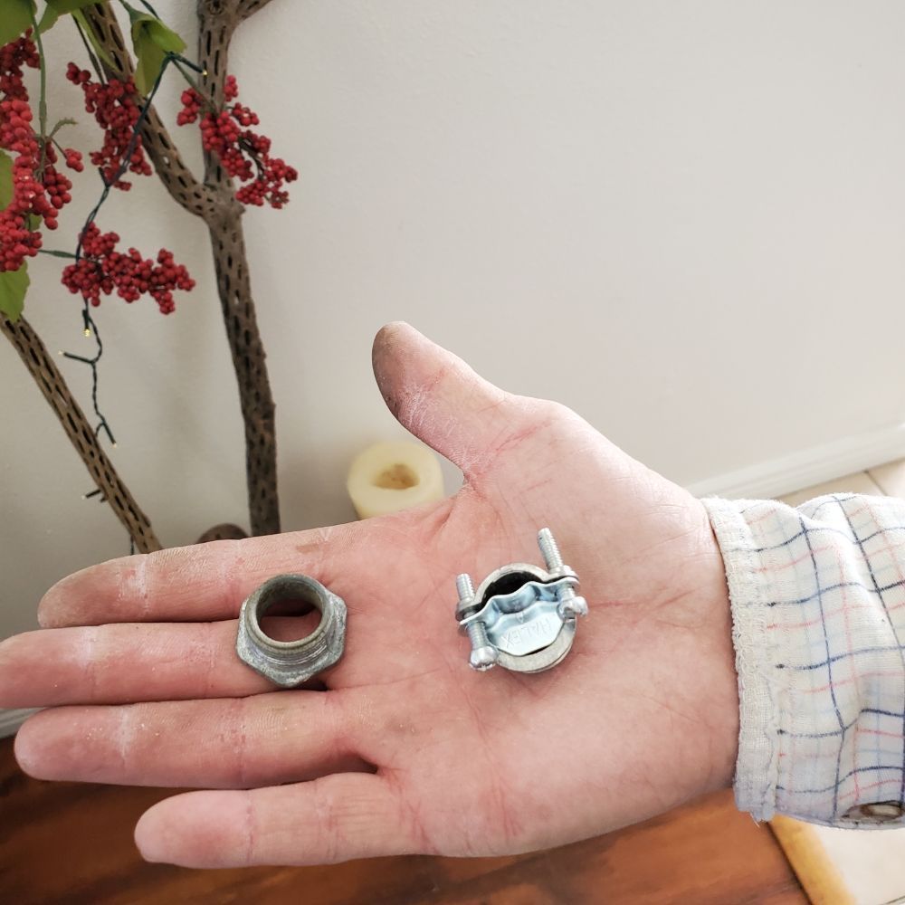 A person is holding a small metal object in their hand
