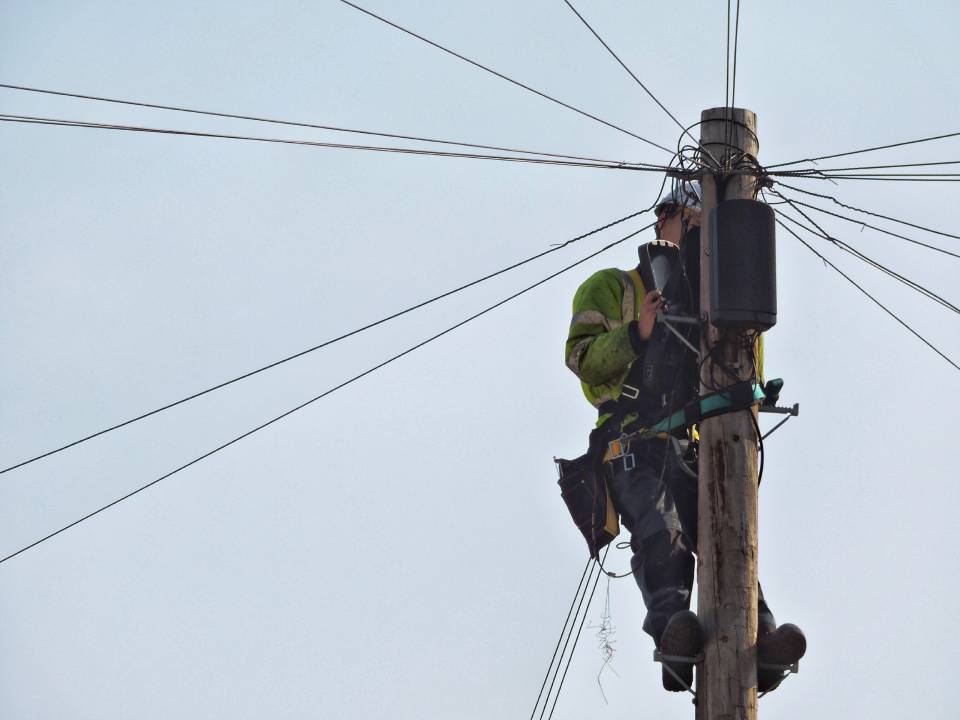 man on an electric pole