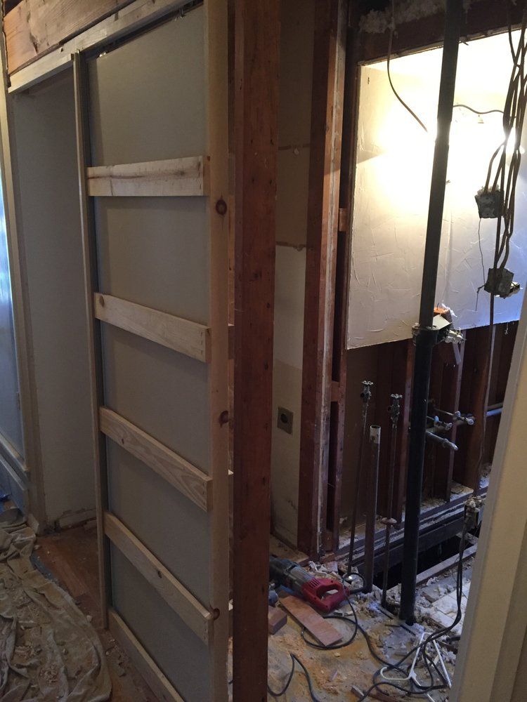 A door is being built into a wall in a bathroom.