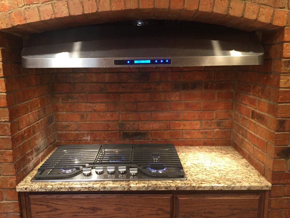 A man is installing a counter top in a kitchen.