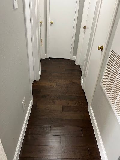 A person is using a screwdriver to screw a screw into a piece of wood.