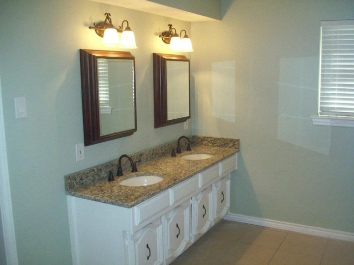 A bathroom with two sinks and two mirrors
