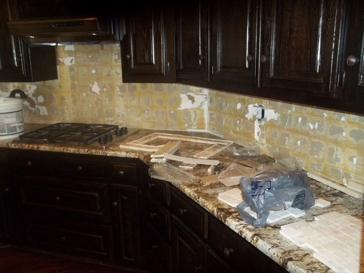A kitchen with black cabinets and granite counter tops