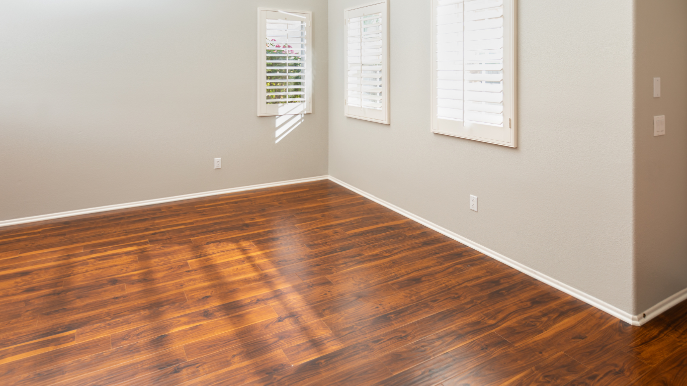 Empty room with gray walls, beige carpet, a black sliding door, and a globe light fixture.
