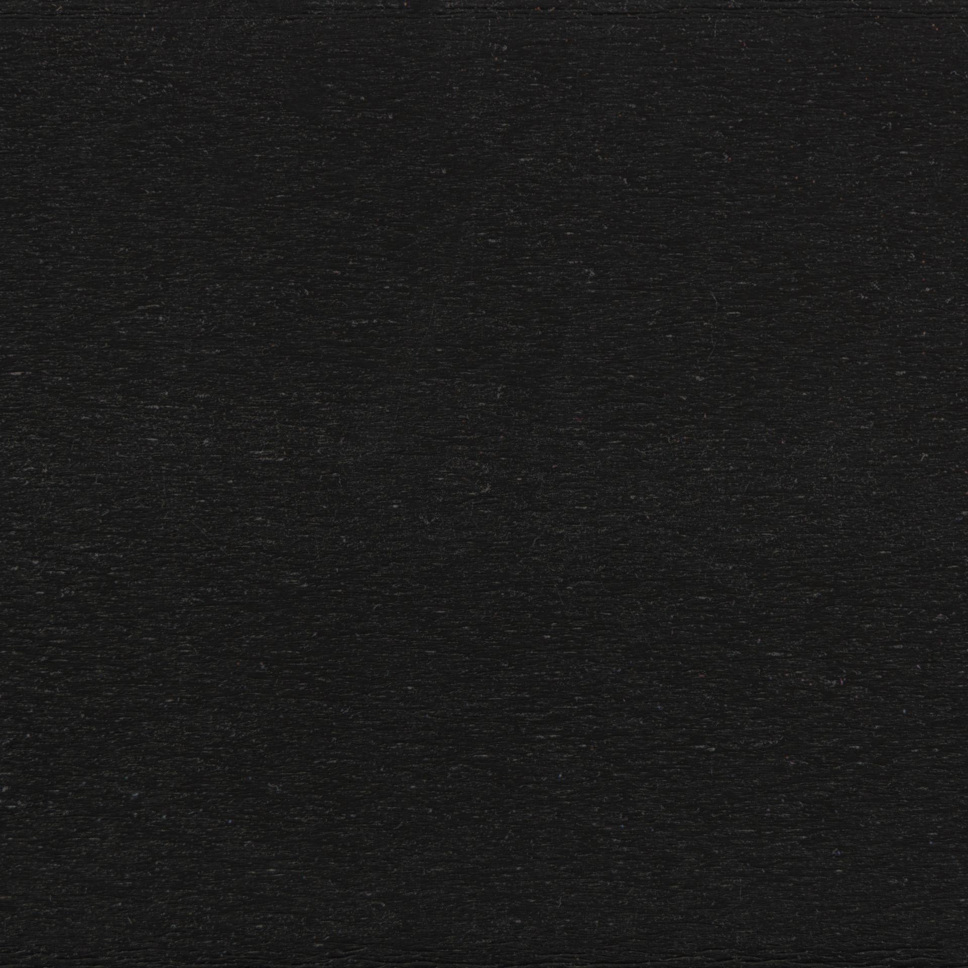Dark textured black surface with subtle horizontal grain