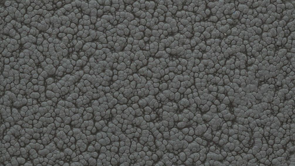 Gray pebbled stone or asphalt texture filling the frame