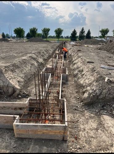 A group of construction workers are working on a construction site.