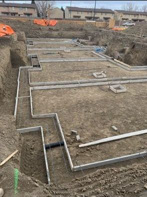 A construction site with a lot of dirt and concrete.