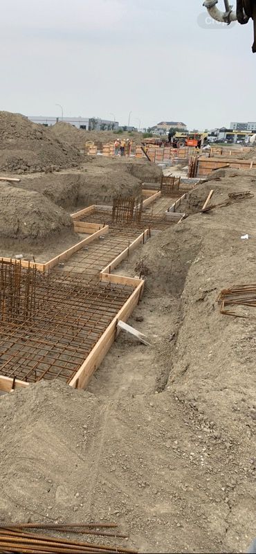 A construction site with a lot of dirt and concrete.
