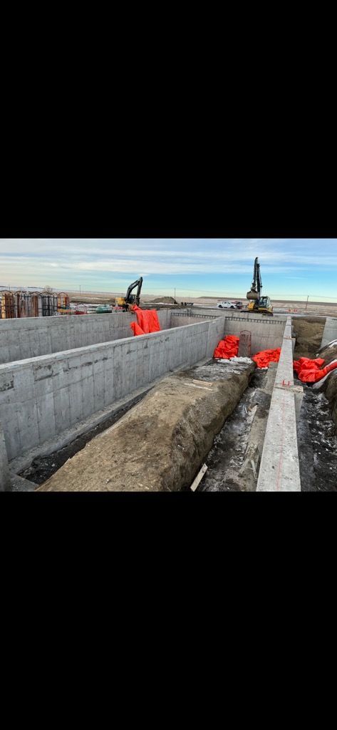 A large concrete structure is being built on top of a road.