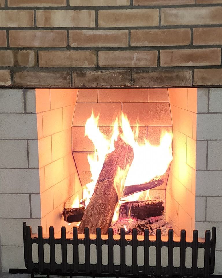 A fireplace with a brick wall and a fence around it