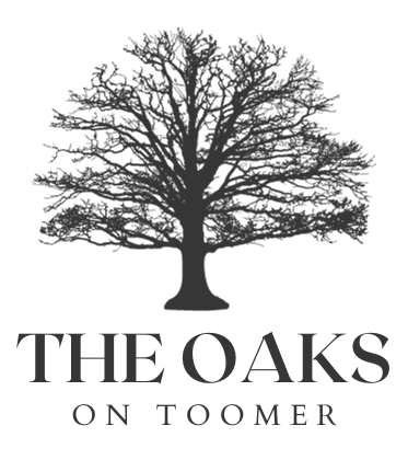 The Oaks on Toomer A black and white logo for the oaks on toomer, a luxury development in downtown auburn, alabama