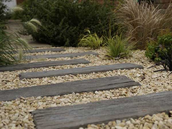 A walkway built by  using repurposed wood and stone