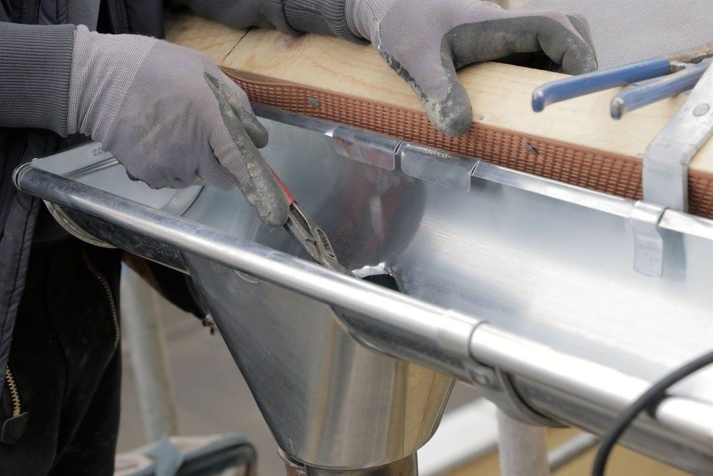 Checking Gutter Drainage — Exterior Pressure Cleaning In Bega Valley, NSW