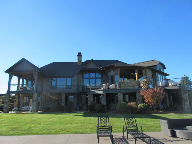 A large house with a large lawn in front of it.