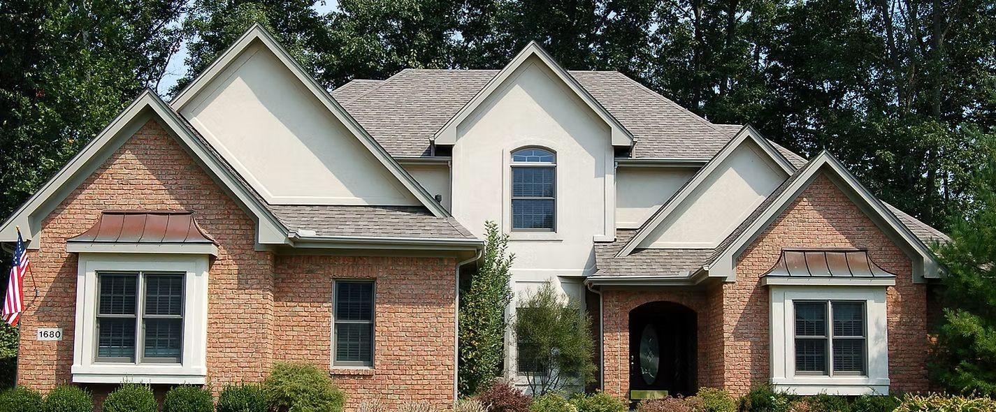 A large brick house with a white roof