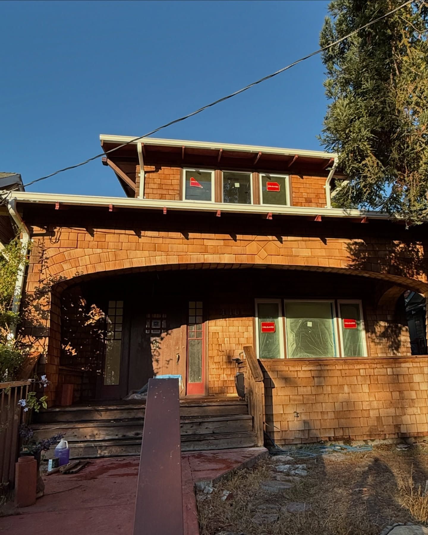A house with a lot of windows and a blue sky in the background