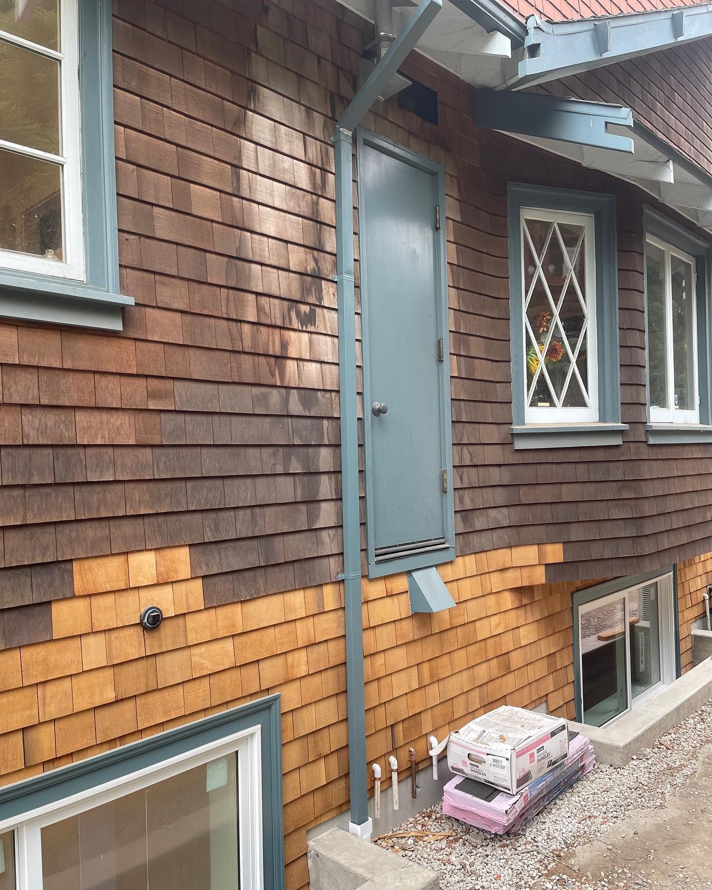 A brown house with a blue door and windows