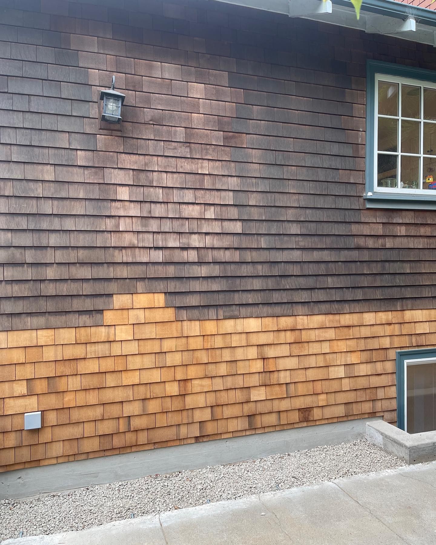 A house with a brick wall and a window
