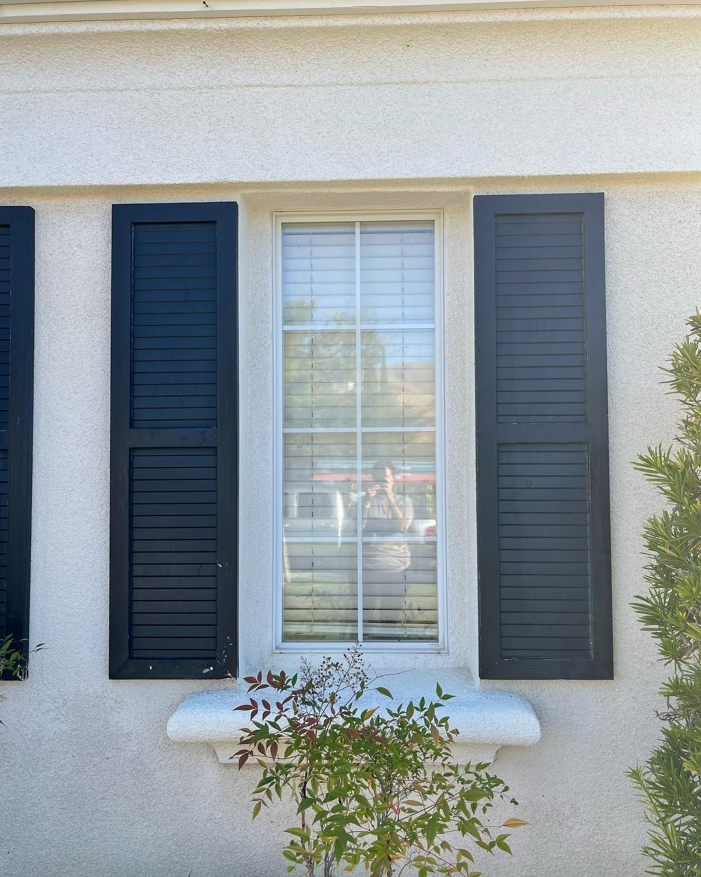 A white house with black shutters on the windows