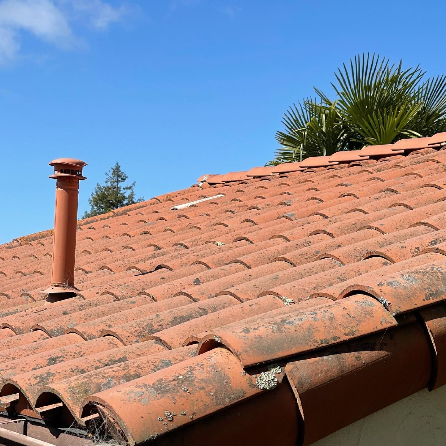 A tiled roof with a chimney on top of it