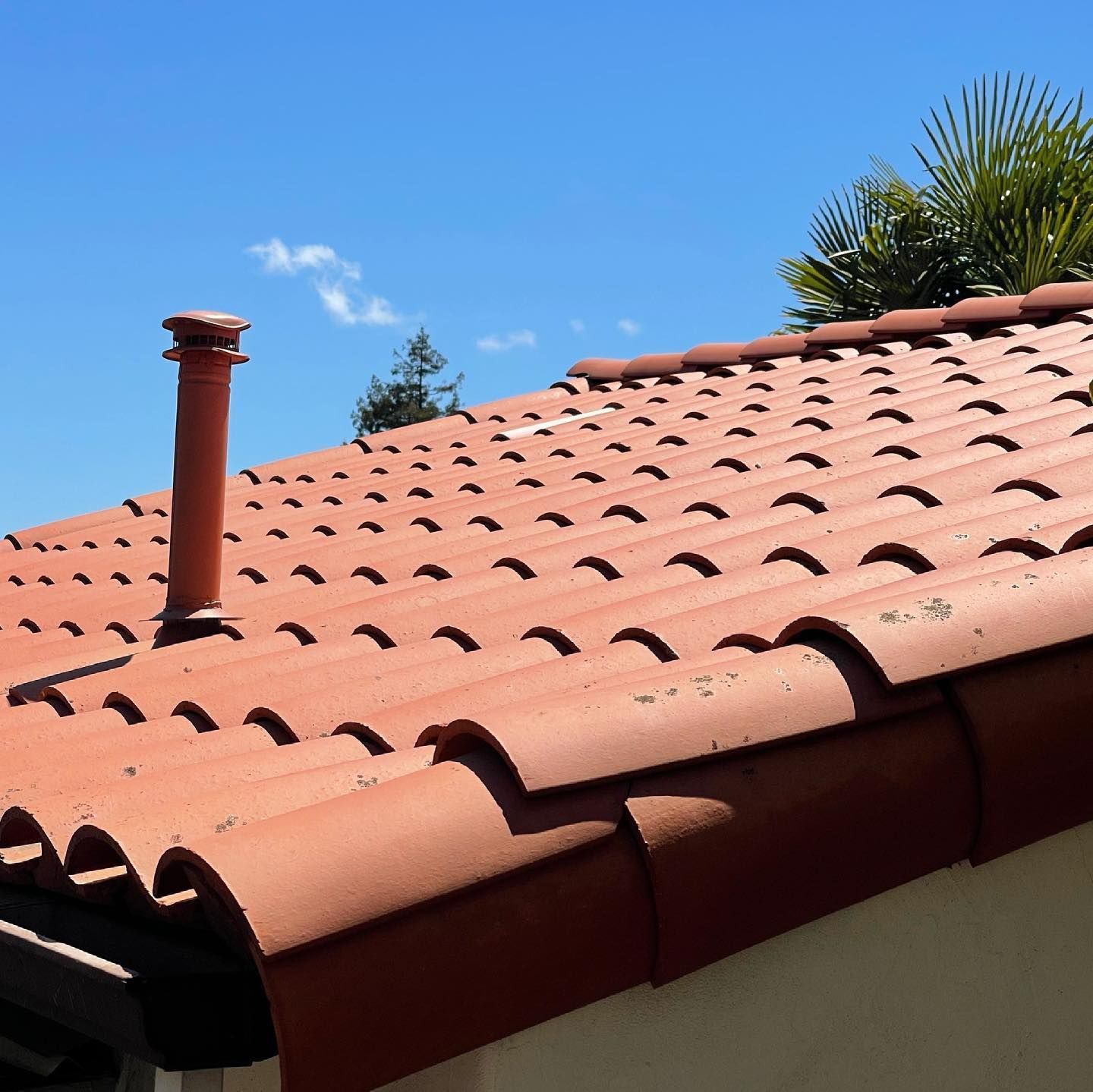 A tiled roof with a chimney on top of it