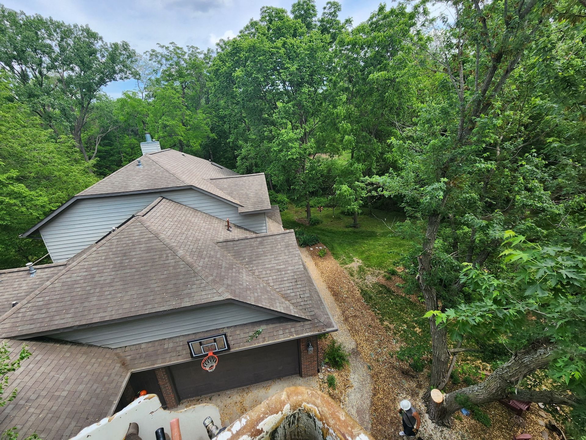 An aerial view of a house surrounded by trees.