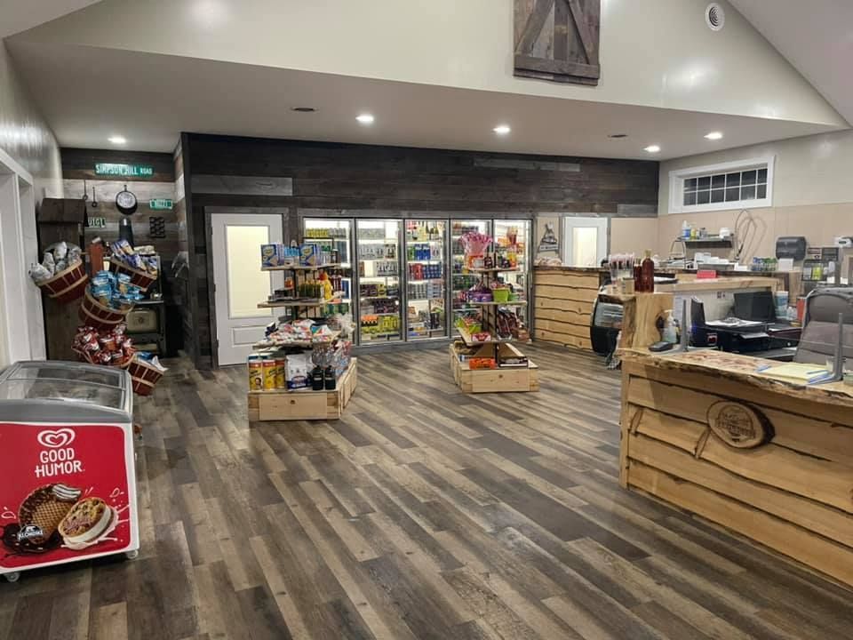 The inside of the camp store with a freezer and a counter.