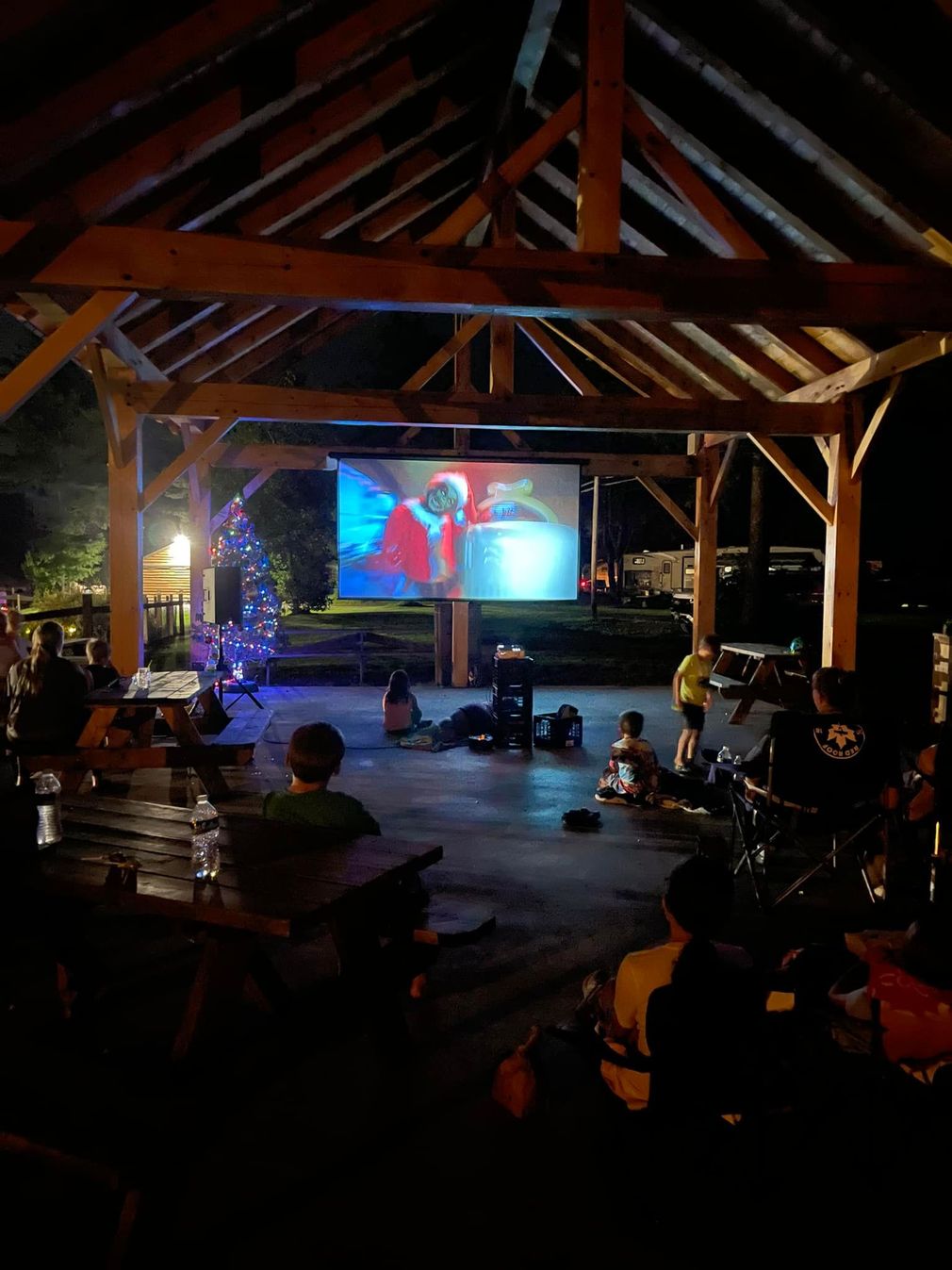A group of people are watching a movie on a large screen