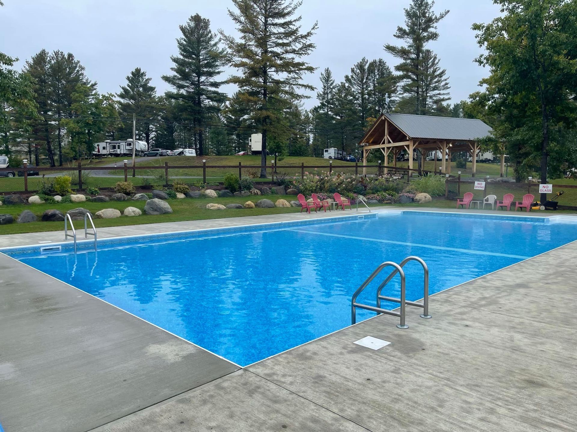 A large heated salt water swimming pool with a gazebo in the background