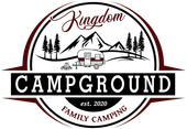 A logo for Kingdom Campground family camping with a camper and mountains in the background.