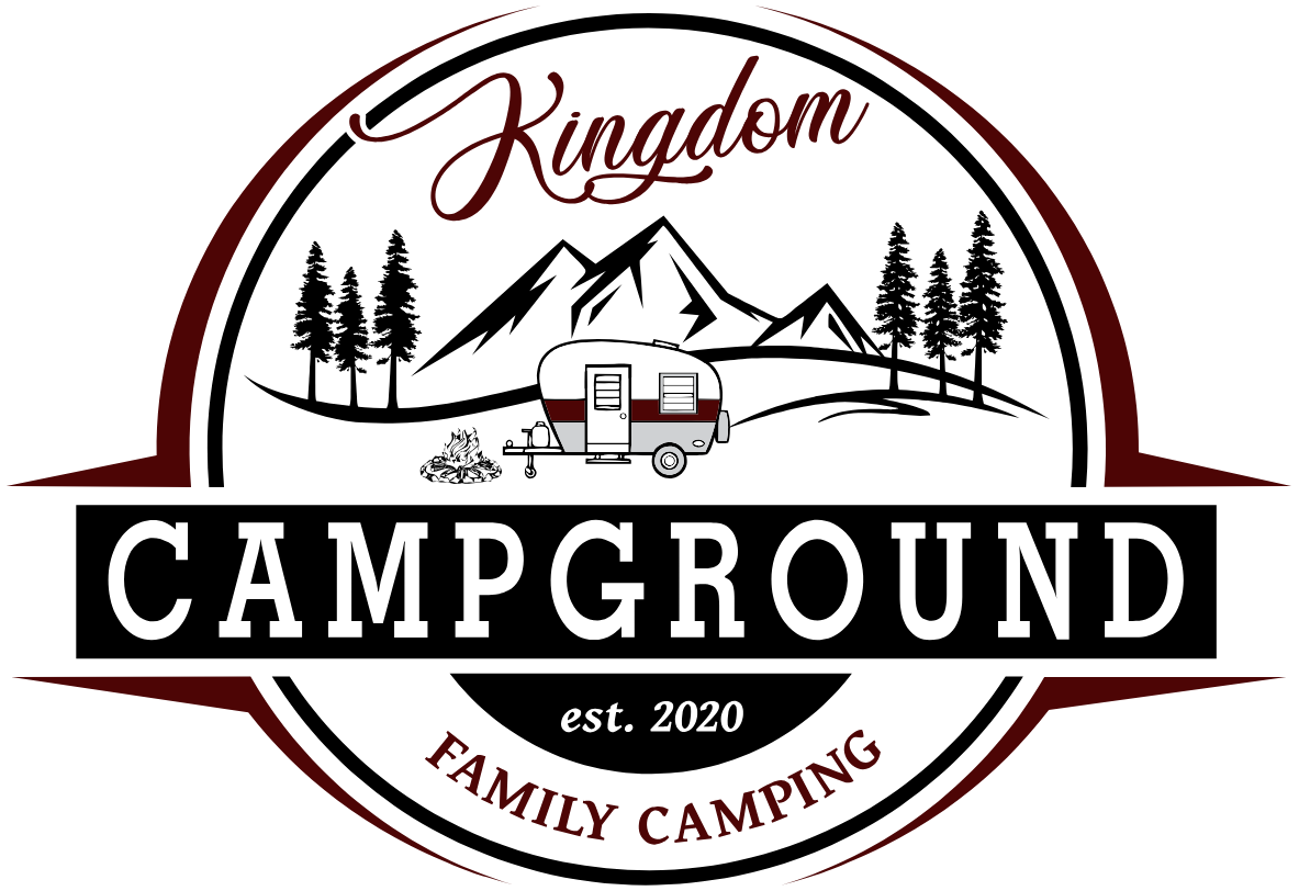 A logo for Kingdom Campground family camping with a camper and mountains in the background.