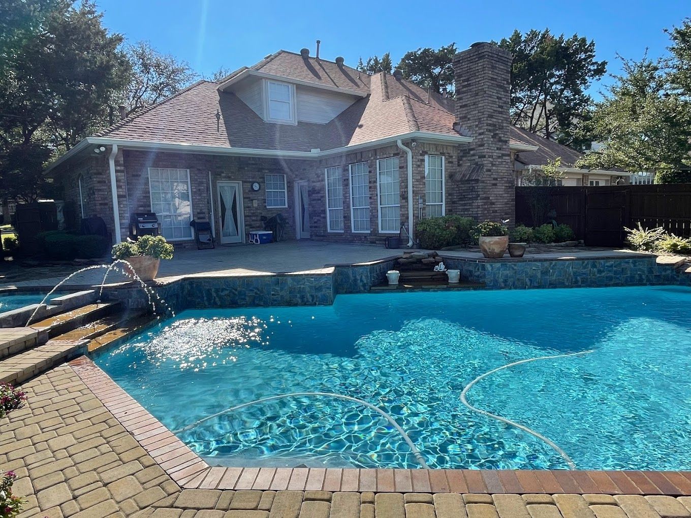 A large swimming pool in front of a house