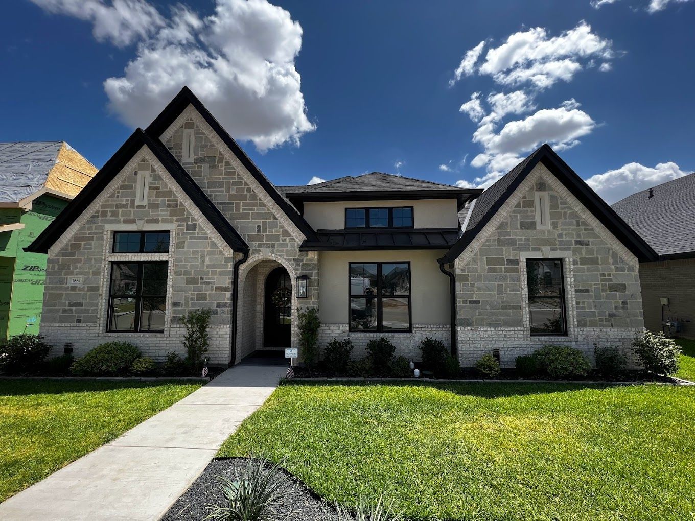 A house with a brick facade and a black roof