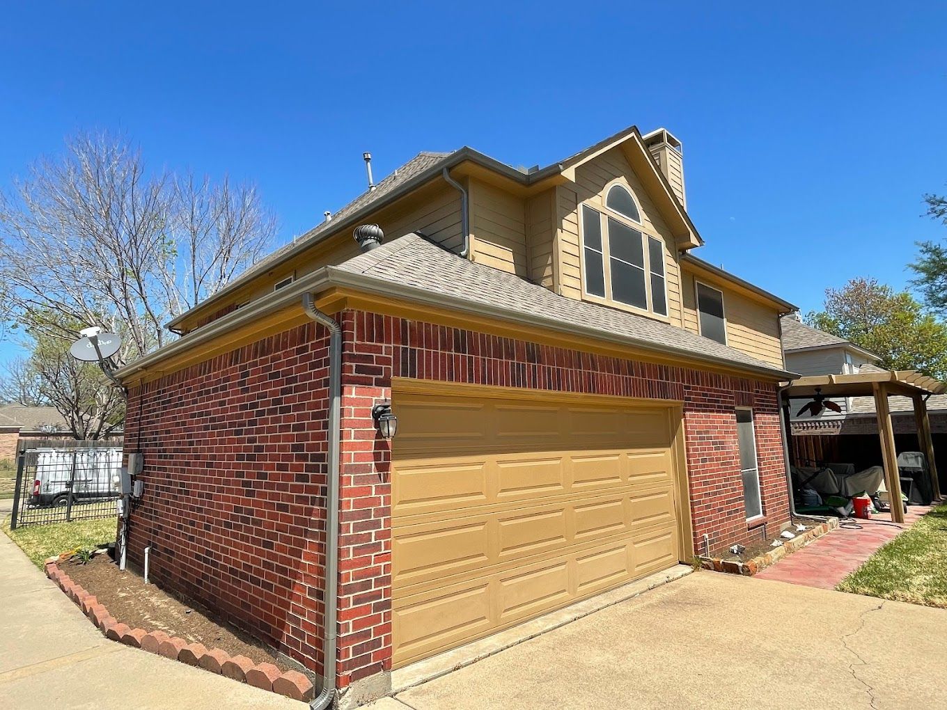A large brick house with a large garage and a large window.