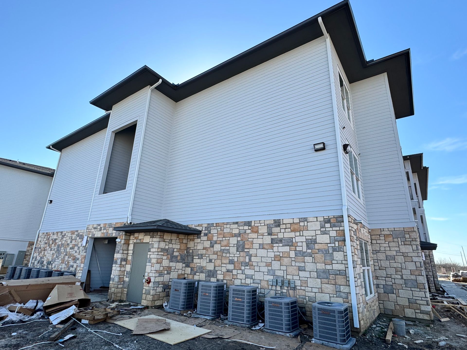 A building with a lot of air conditioners on the side of it