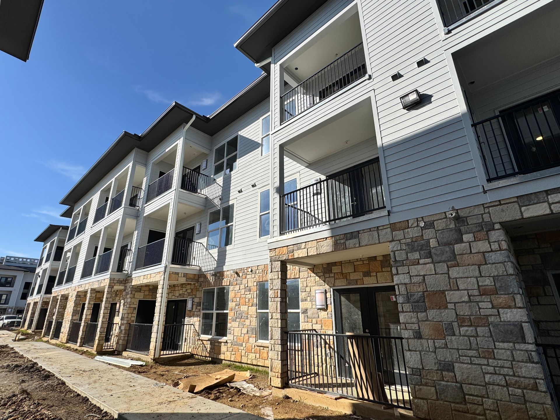 A large apartment building with a lot of balconies and windows.