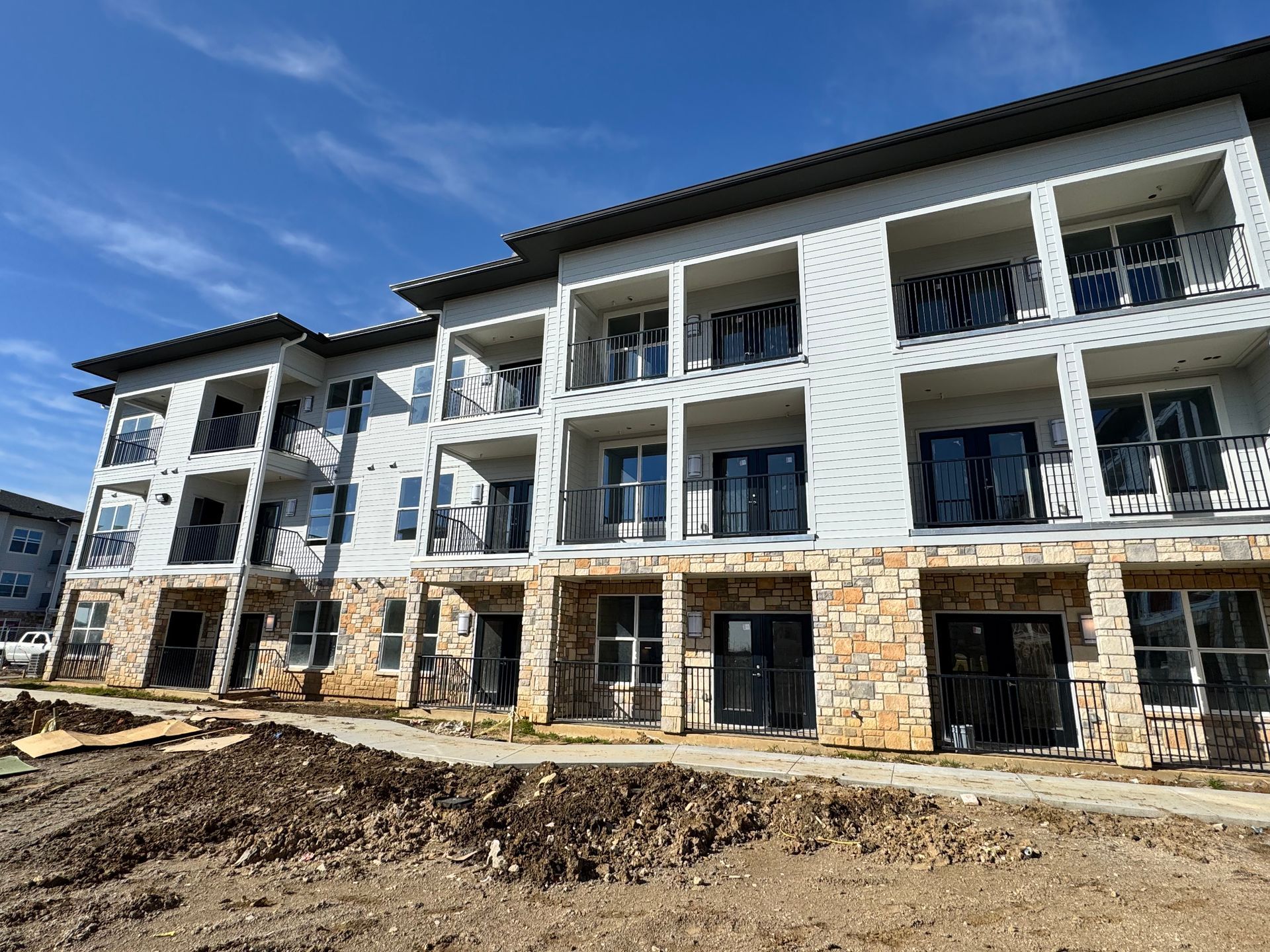 A large apartment building under construction with a lot of windows and balconies.