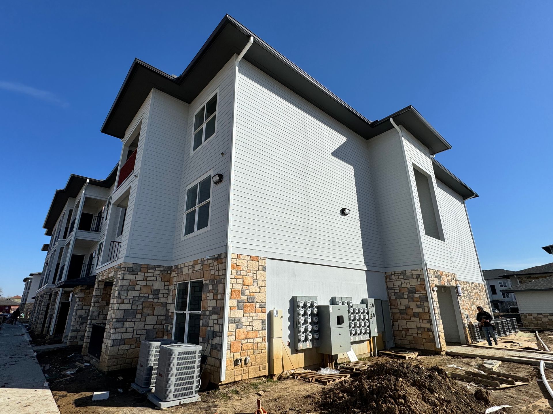 A large white building with a blue sky in the background