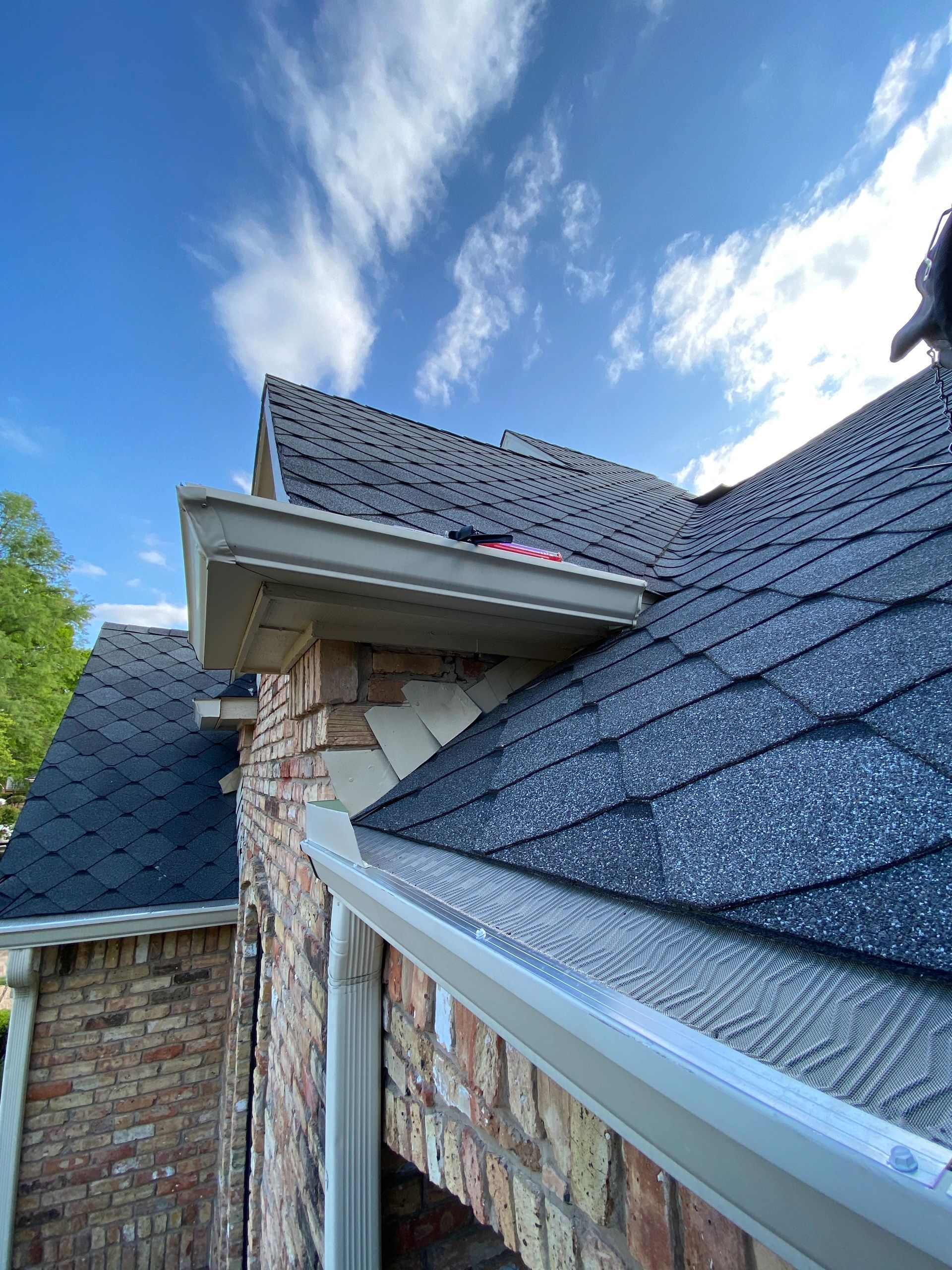 A person is working on the roof of a house.