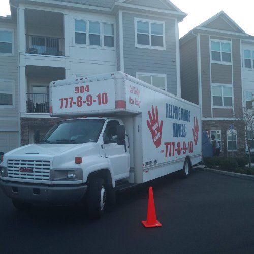 Long-Distance Moving — Two Movers Holding A Large Box in Jacksonville, FL
